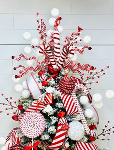 a christmas tree decorated with candy canes and ornaments