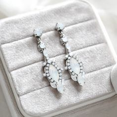 Our amazing white opal crystal earrings are a perfect choice for a bride looking for a modern vintage style.  So much detail in these beauties !   - Handcrafted with genuine Austrian Crystals - Each stone is set by hand in my studio - White opal crystals - Antique silver finish - Earrings measure 2-1/8 inches - Handcrafted in the US. - Nickel free and hypoallergenic - PLEASE ALLOW APPROX 10 DAYS FOR COMPLETION BEFORE SHIPPING This is an original design by © Treasures by Agnes Browse our earrings: https://www.etsy.com/shop/treasures570?ref=seller-platform-mcnav§ion_id=6861728 Browse our backdrop necklaces: https://www.etsy.com/shop/treasures570?ref=seller-platform-mcnav§ion_id=11378666 Browse our necklaces: https://www.etsy.com/shop/treasures570?ref=seller-platform-mcnav§ion_id=6800043 Brow Bridal Jewellery Inspiration, Rose Gold Wedding Jewelry, Modern Vintage Style, Backdrops Necklace, Modern Vintage Fashion, Jewelry Antique, Bridal Bracelet, Perfect Palette, Wedding Jewelry Earrings