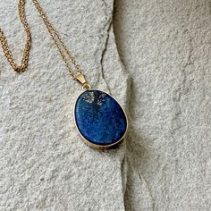 Lapis Lazuli Pendant Necklace, Gold Blue Drop Pendant, September Birthstone, Lapis Lazuli Jewelry, Gift for Her, Blue Gemstone Necklace This listing is for one necklace -  Natural Lapis Lazuli pendant  -  Gold-plated Chain Necklace Size of the pendant: about 20mm wide, 35mm long                                              LAPIS LAZULI: Keywords:  Truth, Inner Power, Organization LAPIS LAZULI  is a stone of communication that can bring truthfulness, openness, and mental clarity. It is used to he Blue Raw Stone Spiritual Jewelry, Spiritual Blue Raw Stone Jewelry, Blue Lapis Lazuli Round Necklace, Blue Lapis Lazuli Necklaces With Stones, Blue Lapis Lazuli Necklace With Stones, Blue Lapis Lazuli Oval Jewelry, Blue Gemstone Crystal Necklace As A Gift, Blue Lapis Lazuli Stone Necklace, Blue Handmade Crystal Round Pendant Necklace