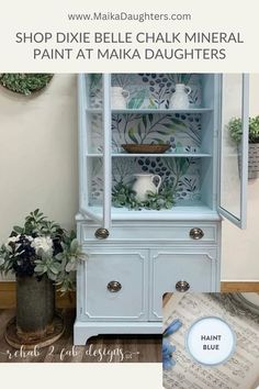 an old china cabinet painted in blue and white with flowers on it, along with the words shop dixie belle chalk mineral paint at maka daughters