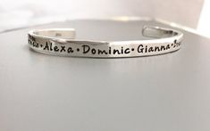 A sterling silver shiny cuff bracelet with your message, names, and/or dates stamped on bracelet. This bracelet is of incredible quality. SIZE…………………………………………………………….Length: 15cm or 6” Height :  5.0mm or .02"Width: 2mm  Gauge: 13FONT…………………………………………………………….Font shown: Whimsy (photo 1/3)  TYPE CAP (photo 2)   **but can be most fonts in last picture      Will happily leave letters unblackened or buff a matte finish if you prefer.  Leave In Notes to Seller at checkout. CHECKOUT..................... Custom Text Adjustable Sterling Silver Jewelry, Meaningful Silver Jewelry With Custom Text, Classic Sterling Silver Custom Name Bracelet, Classic Customizable Sterling Silver Name Bracelet, Customizable Classic Sterling Silver Name Bracelet, Customizable Classic Sterling Silver Bracelets, Classic Customizable Sterling Silver Bracelets, Personalized Sterling Silver Meaningful Bracelets, Classic Personalized Sterling Silver Bracelet For Anniversary