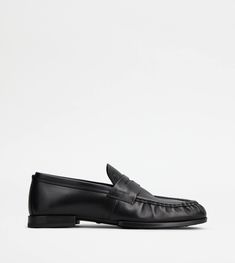 Loafers in fine brushed calfskin leather, with gathered toe, penny bar and stamped Tod's monogram. Featuring a rubber outsole with embossed tubber pebbles and horseshoe-shaped heel, they are a versatile and timeless style. Black Loafers, Monogrammed Leather, Loafers Men, Penny, Calf Skin, Timeless Fashion, Leather Upper, Loafers, Monogram