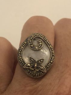 Vintage hand made about an in long Mother of Pearl set in 925 Sterling Silver Marcasite ring I have size 5.5 Can be re sized for you, my jeweler would charge $10 All rings are shipped in a nice gift box. Check out our over a THOUSAND great reviews Engraving is $4 per letter and is not always perfect depending on the piece. It can take a few days if the jeweler is busy. This is payable to Paypal Judithsltd@gmail.com Unique Sterling Silver Butterfly Ring, Handmade Silver Victorian Rings, Handmade Victorian Silver Rings, Sterling Silver Butterfly Ring For Wedding, Unique Sterling Silver Butterfly Ring For Wedding, Vintage Sterling Silver Butterfly Ring For Anniversary, Elegant Round Butterfly Ring Stamped 925, Handmade Sterling Silver Butterfly Ring For Anniversary, Elegant Butterfly Wedding Ring Stamped 925