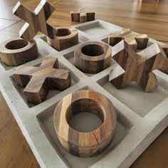 several wooden objects are arranged on a tray in the shape of stars and pentagons