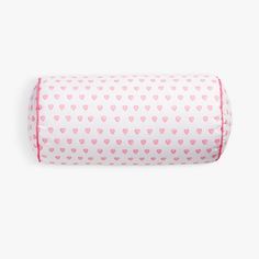 a roll of pink and white polka dot paper with hearts on it, sitting on a white surface