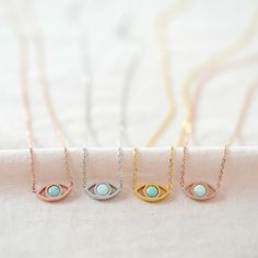 "The Evil Eye is a popular amulet symbolizing a protection against bad luck. - available in WHITE & MINT Opal in gold, silver and rose gold finish. The evil eye is also referred to as the \"lucky eye.\" Keep the evil eye closed to you to bring you luck and ward off negativity! D E T A I L S - Classic & Timeless Dainty Opal Evil Eye - Eye size : 12mm x 6mm (1/2\" x 1/4\") - White Opal or Mint Opal of your choice (white opal is not pure white, it's closer to 'bluish white') - Each piece or Evil Eye Round Pendant Necklace Gift, Spiritual Birthstone Charm Necklace As Gift, Spiritual Birthstone Charm Necklace For Gift, Spiritual Adjustable Birthstone Necklace As A Gift, Adjustable Spiritual Birthstone Necklace As A Gift, White Round Pendant Necklace For Good Luck, Spiritual Birthstone Necklace For Birthday, White Necklace For May Birthstone Gift, Spiritual Round Birthstone Necklace