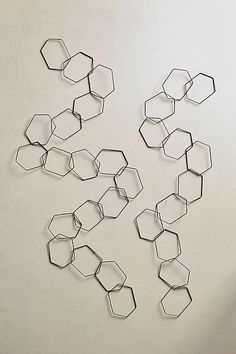 a group of metal hexagonal shapes on a white wall