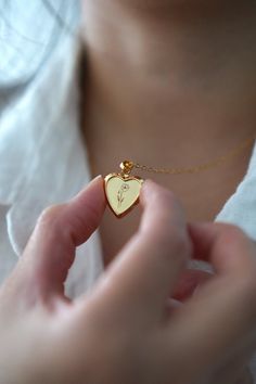 18-karat gold plated heart locket hangs on a sturdy 18-karat gold plated stainless steel chain.  Choose your chain length from the drop-down menu.   This locket is perfect for using as a keepsake necklace and is a thoughtful gift for someone special in your life. You can choose the locket as is, without photos, or have it personalized with your photo (s) and engraved your birth flower. You choose your options at checkout.  A mock-up of the photo will be done for your approval. Once approved, I w Anniversary Jewelry With Initial Pendant And Flower Charm, Gold Charm Necklace With Flower For Anniversary, Gold Flower Charm Necklace For Anniversary, Rose Gold Locket Necklace With Charms For Gift, Rose Gold Heart Pendant Jewelry With Flower Charm, Gold Plated Jewelry For Valentine's Day Anniversary, Mother's Day Jewelry With Birth Flower Medallion, Tarnish Resistant Jewelry For Valentine's Day Gift, Valentine's Day Gift Tarnish Resistant Jewelry