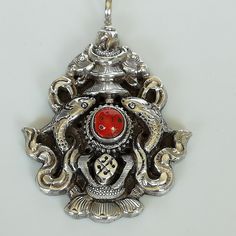 ▪︎ A nepalese and tibetan oxidized 925 silver vintage pendant. The pendant is embedded with a red carnelian stone surrounded by beautiful fish and other good luck symbol carving. ▪︎ Perfect as a charm for necklaces, keychains. ▪︎ This pendant is handmade with hypoallergenic sterling silver. All our jewels are stamped with hallmark 925, indicating the purity of the silver. ▪︎ Size:- 35 x 51 mm ( including jump ring) Jump ring: 7mm ▪︎ Please note: This pendant comes WITHOUT the chain, however, you Spiritual Antique Silver Jewelry With Large Pendant, Spiritual Large Pendant Jewelry In Antique Silver, Symbolic Red Pendant Jewelry, Red Spiritual Engraved Necklace, Unique Sterling Silver Necklace For Rituals, Unique Sterling Silver Necklaces For Rituals, Antique Silver Spiritual Pendant Necklace, Red Engraved Spiritual Necklaces, Red Engraved Spiritual Necklace