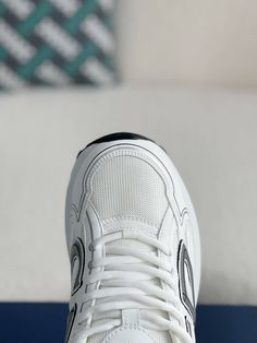 Embrace a sleek and sporty aesthetic with these Dior B30-inspired sneakers in a pristine white colorway. Crafted with breathable mesh and technical fabric, these shoes are perfect for those who value style and performance. The lightweight construction and sculpted rubber sole ensure all-day comfort and support, while the signature "CD30" logo adds a touch of Dior's iconic style. Whether you're hitting the gym or the streets, these sneakers will elevate your look with a touch of understated luxur White Breathable Chunky Lace-up Sneakers, White Mesh Sneakers With Boost Midsole, Classic White High-top Sneakers For Jogging, White Mesh Sneakers With Comfortable Midsole, Dynamic White High-top Sneakers With Laces, White Mesh Sneakers With Laces, White Breathable Lace-up Chunky Sneakers, Modern White Mesh Chunky Sneakers, White Sneakers With Air Cushioning For Jogging