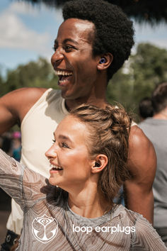 two people standing next to each other smiling