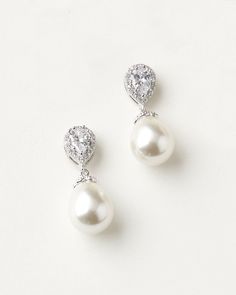 Timeless & stunning, our Nina Pearl & CZ Earrings are the perfect combination of CZs & pearls in a delicate drop. Available in silver, these earrings are perfect for brides & bridesmaids alike. Wear these earrings on your wedding day or special occasion. Pear-shaped Pearl Drop Bridal Earrings In White Gold, White Cubic Zirconia Crystal Earrings With Elegant Design, Elegant White Pearl Embellished Earrings, White Gold Bridal Earrings Teardrop Elegant Design, Elegant Teardrop White Gold Bridal Earrings, Elegant White Gold Teardrop Bridal Earrings, Classic White Pear-shaped Teardrop Earrings, Teardrop Pearl Earrings With Cubic Zirconia For Party, Elegant Pearl Earrings With Cubic Zirconia