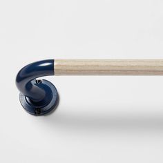 a wooden handle on a blue and white push button for a toy scooter