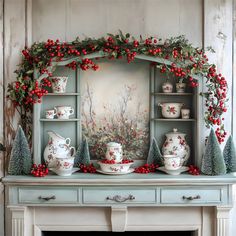 a fireplace mantle decorated for christmas with red berries and greenery