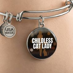 Get our Childless Cat Lady Bracelet today and be amazed by its quality and style! Made with durable surgical steel and the option for 18k gold finish, this jewelry item is the ultimate keepsake for yourself or your loved ones. Plus, we offer a 100% Happiness Guarantee - if for any reason you're not completely satisfied, just let us know and we'll make it right. Your satisfaction is our top priority. Product Dimensions➜ Luxury Bangle: 7-9" (18-22.75cm). This bangle features a stretchable design that allows it to expand as you slide it onto your wrist, then it effortlessly returns to its original shape.➜ Circle Pendant: 23.5mm x 23.5mm. Bracelet Luxury, Shape Circle, Bangle Silver, Bangle Gold, Top Priority, Circle Pendant, Gold Bangles, Cat Lady, Womens Bracelets