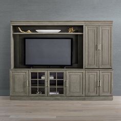 a large entertainment center with a television on top