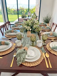 the table is set with dishes and place settings