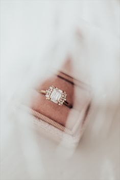 While listening to the song "1922", by the band Box the Oxford, Sarah was inspired to create this amazing collection. So of course, we had to name a ring after them! Our Oxford 14k gold ring rocks a vintage vibe while being thoroughly modern. The brilliant emerald cut 1 ct center stone sets the architectural tone, while the .17 ct tapering side baguette and round diamonds make this stunner truly sing. Emerald Cut Baguette Diamond Promise Ring, Baguette Cut Emerald Ring With Center Stone For Promise, Emerald Cut Cluster Ring With Prong Setting For Proposal, Emerald Cut Diamond Ring With Accents For Proposal, Baguette Cut Ring With Center Stone For Proposal, Proposal Rings With Diamond Accents And Baguette Cut, Fine Jewelry Diamond Ring For Proposal With Baguette Cut, Diamond Ring With Baguette Diamonds In Octagon Shape, Baguette Cut Diamond Accent Proposal Ring