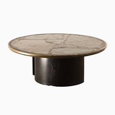 a round table with a marble top and black base, on a white background for display