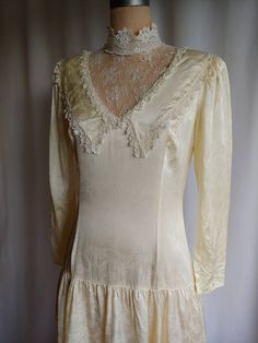 "Beautiful Victorian wedding dress with a dropped waist Silky smooth fabric Lace high collar Back zipper Label - Gunne Sax Size 11 Bust - 36\" Waist - 30\" Hips - 40\" Back - 14\" Sleeve - 21\" Length - 48\" Excellent vintage condition Gently washed and steamed" Fitted Lace Trim Wedding Dress, Fitted Bias Cut Wedding Dress, Vintage Wedding Gown With Bias Cut, Fitted Wedding Dress With Lace Collar, Fitted Cream Bias Cut Gown, Cream Fitted Wedding Dress With Lace Trim, Fitted Cream Wedding Dress, Victorian Wedding Dress, Wedding Dress Lace