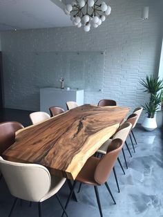 a large wooden table surrounded by chairs in a room