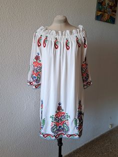 White tunic dress with multicolor floral embroidery, long wide sleeves, elasticated neckline, loose fit with lining. Composition - 100% viscose, marked size L XL. Measurements are taken in horizontal position: Armpit to armpit - 52 cm/20,5'' Length - 83 cm/ 32,6'' Very good condition, on the last pictures you can see loose threads on embroidery. Long Sleeve Embroidered Folk Peasant Dress, Folk Style Long Sleeve Embroidered Peasant Dress, Spring Vacation Long Sleeve Peasant Dress, Casual White Embroidered Long Sleeve Dress, White Long Sleeve Embroidered Dress With Floral Print, Casual White Long Sleeve Embroidered Dress, Long Sleeve Floral Embroidered Dress For Vacation, White Embroidered Long Sleeve Dress With Floral Print, Casual White Embroidered Dress With Long Sleeves