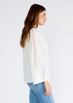 A classic white bohemian top with crochet trim and long flared sleeves. Cotton Relaxed fit Long bell sleeves Split v-neckline Crochet trim Sheer Bohemian spring top The dreamiest top of the season. This classic bohemian blouse features long bell sleeves, a split v-neckline, and delicate crochet trim throughout. Perfect for warmer weather, we love to pair it with our favorite vintage denim and a simple sandal. Model is 5'9, wearing a size S.Style: I-15321W-SQV Peasant Style V-neck Blouse For Brunch, Bohemian Cotton Peasant Top With Lace Trim, Chic Long Sleeve Tops With Cutwork Hem, Bohemian Tops With Lace Sleeves For Fall, Bohemian Flowy Top With Lace Trim, Bohemian V-neck Lace Top For Vacation, Summer Long Sleeve Tops With Cutwork Hem, Long Sleeve Summer Tops With Cutwork Hem, Cotton Crochet Top With Lace Trim And V-neck