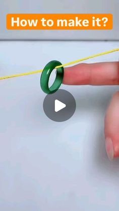 a person is pulling a ring on a string