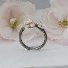 A pretty handmade flower ring based on the Japanese Cherry Blossom in silver and gold. Inspired by Japanese culture and the beautiful cherry blossom, this ring has been hand crafted from sterling silver which has been oxidised to represent the black branches. Cherry blossom has long been symbolic of celebrations and the cycle of life, making this a perfect treat for yourself or a special gift for loved ones. Set with silver blossom with solid gold centres this is a special ring to treasure. Matc Nature-inspired Round Flower Ring For Anniversary, Flower-shaped Rose Cut Diamond Jewelry For Anniversary, Flower Shaped Rose Cut Diamond Jewelry For Anniversary, Anniversary Jewelry With Rose Cut Diamonds In Flower Shape, Nature-inspired White Gold Promise Jewelry, White Gold Nature-inspired Jewelry For Promise, Nature-inspired Nickel Free Anniversary Ring, Sterling Silver Rose Cut Diamond Jewelry For Promise, Fine Jewelry Hand Forged For Promises