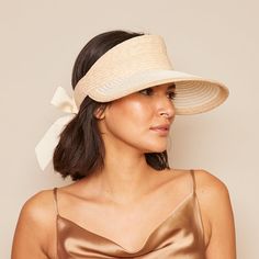 Our Ricky' visor looks so chic as it protects your face from the sun. It's woven from a Natural and Ivory two-tone straw and finished with an elasticated panel lined with smooth satin at the back topped with flowing ivory grosgrain ties.Measurements: HEADSIZE: 6.5" / 2.75" X 4.50"Spot cleanImported Elegant Straw Visor Hat, Elegant Boater Hat With Visor For Spring, Elegant Beige Visor Sun Hat, Elegant Spring Boater Hat With Visor, Elegant Boater Hat With Visor For Vacation, Elegant Visor Boater Hat For Vacation, Elegant Adjustable Straw Hat With Upf 50+, Elegant Visor Straw Hat For Vacation, Elegant Vacation Visor Straw Hat