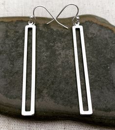 "Simple, refined and super stylish long modern earrings. They are eye catching and versatile. Dress them up or down. The perfect everyday earrings. The earrings measure 2\" long 1/4\" wide. They hang from simple silver ear wire hooks. Overall drop length is 2 1/8\". Made from plated rhodium. I have this same earring style available in gold as well. Here is a direct link https://www.etsy.com/listing/1257242061/ Thanks for stopping by! Please take a moment and visit the rest of my Etsy shop. I hav Earrings Long Silver, Modern Silver Earrings, Long Silver Earrings, Rectangle Earrings, Unique Jewelry Designs, Earrings Minimalist, Everyday Earrings, Modern Earrings, Etsy Earrings Dangle