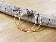 White, olive, mustard, and rust seed beads. 1 ³/⁴ inches in diameter. Nickel free hoops. Choose gold or silver hoops. Return to shop 👇 https://www.etsy.com/shop/AxeandSparrow PLEASE MAKE SURE YOUR ADDRESS IS ENTERED CORRECTLY. IF YOU ARE DOING A GUEST CHECKOUT PLEASE PLEASE DOUBLE CHECK YOUR ADDRESS AND YOUR EMAIL. THANK YOU! *All feathers are cruelty free. All hooks are lead and nickel free. All leather is genuine leather. *Please feel free to contact me with ANY questions or custom creations. Beaded Hoops, Seed Bead Earrings, Silver Hoops, Custom Creations, Boho Earrings, Delicate Bracelet, Beaded Earrings, Seed Beads, Genuine Leather