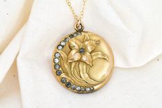 The perfect gift for a bride, mother, graduate, or birthday. Find affordable antique and vintage inspired jewelry here. Personalize by adding sentimental pictures, a tiny note, or a lock of hair. Select the customization option if you would like me to personalize before shipment. This Art Nouveau style locket features a raised flower with sparkling paste accents arranged in a crescent shape. This locket was made by Wightman & Hough Co. (W&H CO.) which was based in Providence, Rhode Island. They Sentimental Pictures, Locket Pendant Necklace, Crescent Shape, Pendant Necklace Gold, Vintage Inspired Jewelry, Hair Locks, Victorian Art, Inspired Jewelry, Locket Necklace