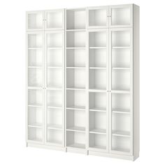 a white bookcase with three doors and two shelves on the front, one is empty