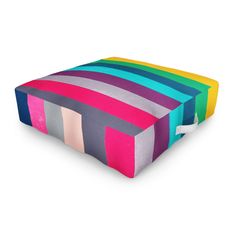 a multicolored square shaped pillow on a white background