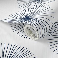 a white and blue wallpaper with palm leaves on it