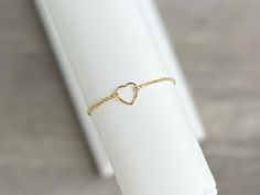 This beautiful 14K gold filled floating heart charm bracelet is adjustable and fits up to an 8" wrist. Bracelet slides to open and secure.  Layer it with any of our gold filled bracelets to create your own personalized stack.  Each bracelet is sold separately* 🤍 14K Gold filled, hypoallergenic; (lead and nickel free)  🤍  NOTE:  Color may vary slightly than picture due to different display devices and settings.   👇🏻 👇🏻 👇🏻 📦📫FREE SHIPPING ON ALL DOMESTIC ORDERS OF $35 OR MORE! 📌CARE:  🤍Keep bracelet in a dry place and away from soaps, chemicals, lotions & sweat. 🤍 Take off your jewelry before sleeping or exercise to avoid any wear and tear. 🤍Gently polish with a soft, lint-free cloth after wearing. Store in a sealed bag or box in a cool, dry place. 📌RETURNS: We accept returns Adjustable Delicate Heart Bracelet, Adjustable Open Heart Bracelet Gift, Adjustable Open Heart Bracelet For Gift, Dainty Adjustable Open Heart Bracelet, Dainty Open Heart Adjustable Bracelet, Delicate Adjustable Bracelets For Valentine's Day, Delicate Adjustable Bracelet For Valentine's Day, Delicate Adjustable Heart Bracelet For Anniversary, Delicate Adjustable Heart Bracelet For Everyday