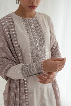 Classic Heavily Embellished Grey Pakistani Salwar Kameez Dupatta is a stunning dress to wear on a festive occasion. This beautiful Salwar Kameez is emblazoned with embroidery, floral designs, motifs, gotta, and mirror details, making it an epitome of beauty and grace. Embroidered Kameez: The kameez has a beautiful blend of grey colors. The premium Silk fabric and hand-crafted details of embroidery make it a chic choice for the big day. Mirror details on the neckline and gota details give a tradi Pakistani Salwar, Dresses Design, Casual Indian Fashion, Pakistani Fancy Dresses, Chique Outfits, Beautiful Pakistani Dresses, Salwar Kamiz, Indian Dresses Traditional, Desi Clothes