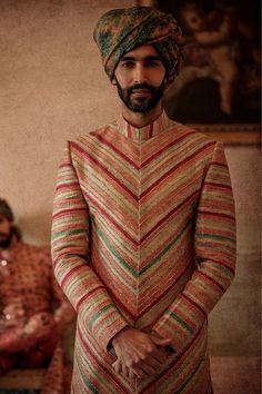 a man with a turban standing in a room