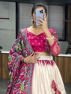 Elevate your traditional wardrobe with this beautiful off-white & pink patola printed silk lehenga choli set, perfect for the upcoming festival season. Crafted from luxurious dola silk material, this outfit features intricate patola and paithni printed work with foil work (crush work) that adds a touch of elegance and sophistication.
The off-white lehenga is stitched up to 42 inches with a 3.8-meter flair, while the pink choli comes with patola printed work and foil work. The set is complete Pink Choli, Work Crush, Traditional Wardrobe, Silk Lehenga Choli, White Lehenga, Pink Lehenga, Traditional Indian Outfits, Silk Lehenga, Stunning Outfits