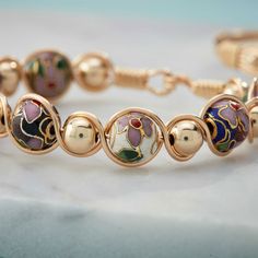 Each cloisonné bead is inlaid with colored enamel, giving the beads a dainty, feminine look. Cloisonne Enamel Jewelry, Faberge Jewelry, Wishlist 2024, Cloisonne Enamel, Jewelry Lookbook, Enamel Jewelry, Feminine Look, Christmas Wishlist, Designer Jewelry