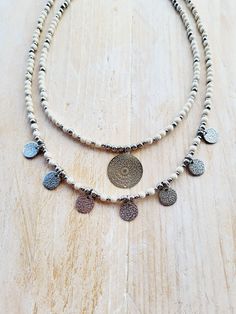 Choose from 2 different styles of boho necklaces in 4mm faux howlite gemstone beads with stainless steel beads and pendants (non tarnish) 1.  Length: 16" (+5cm extender chain)     Coins: 10mm 2. Length: 18" (+5cm extender chain)     Mandala pendant: 20mm ✨️Care for your jewellery by avoiding perfumes and lotions when wearing and remove before bathing. 👉Follow me @Bohoseason on Facebook & Instagram 🤳 Any questions?...i'm happy to help 😊 📦overpaid postage is always refunded White Gemstone Beads Jewelry For Festival, Bohemian Metal Charm Necklaces Adjustable, Bohemian Howlite Beaded Necklace With Gemstone Beads, Handmade Bohemian Charm Necklaces With Round Beads, Bohemian Adjustable Metal Charm Necklaces, Bohemian Handmade Round Beads Charm Necklaces, Bohemian Howlite Gemstone Beaded Necklaces, Adjustable Bohemian Metal Charm Necklaces, Adjustable Bohemian Metal Charm Necklace