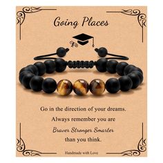 a black bracelet with brown beads and a graduation cap on it that says going places