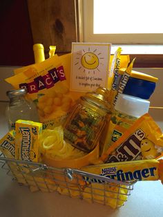 a basket filled with snacks and candy sitting on top of a counter