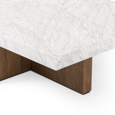 a white marble top and wooden base coffee table