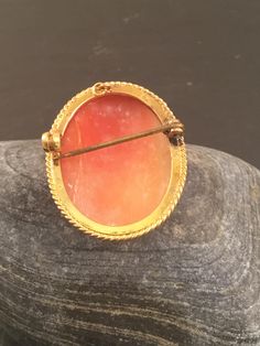 "This is a beautiful vintage 9ct yellow gold cameo brooch. The shell is a dark peach colour with a side view image of a lady in ivory all of which is set in a rope edged 9ct gold casing. There is a small link at the back of the brooch suitable to attach a safety chain if necessary. The brooch/pendant is supplied with a FREE GIFT BOX and I can also gift wrap the brooch if it I sent given as a gift. Dimensions Weight : 7.8g Width : 1\" Length : 1.25\"" Dark Peach Color, Vintage Sapphire Ring, Graduation Rings, Peach Colour, Engraved Wedding Rings, Gold Sapphire Ring, Buckle Ring, Engraved Wedding, Vintage Cameo