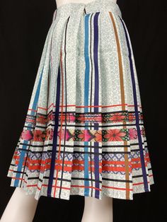 Mexican Fashion Pleated Skirt - Nayibi Mexico Talavera Skirt This elegant skirt is from the Talavera Collection inspired by the tiles of the region of Puebla where they began to make floors made of clay painted by hand taking as reference the Spanish pottery of which the Mexican appropriated this so-called “Talavera”. Lined Backed zipper *Pairs wonderfully with Talavera Top Care/Import Dry clean Import Contents 100% Polyester 100% Polyester Linning Traditional Pleated Skirt For Spring, White Printed Long Skirt, Traditional Multicolor Flared Skirt, Traditional Multicolor Flowy Skirt, Multicolor Skirt With Traditional Patterns, Retro Multicolor Pleated Skirt, Retro Multicolor Midi Skirt, Long Patterned Lined Skirt, Multicolor Long Skirt With Traditional Patterns