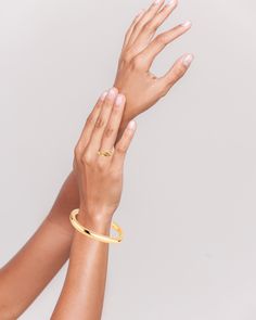 The Loretta Cuff, plated in exquisite 14k gold or silver finish, offers a minimalistic charm. Its versatility makes it a perfect complement to other bracelets. We offer resizing options to ensure the best fit. A timeless classic for your collection. View this post on Instagram A post shared by 𝔹𝕠𝕦𝕟𝕜𝕚𝕥 𝕁𝕖𝕨𝕖𝕝𝕣𝕪 (@bounkitnyc) Modern 14k Gold Bracelets For Everyday Luxury, Timeless Gold Cuff Bracelet With Polished Finish, Luxury Gold Bracelet With Open Band, Luxury Gold Open Band Bracelet, Gold-plated Polished Cuff Bracelet For Formal Occasions, Formal Gold Plated Cuff Bracelet With Polished Finish, Formal Gold-plated Polished Cuff Bracelet, Chic 14k Gold Bracelets For Formal Occasions, Classic Gold Bangle Tarnish Resistant