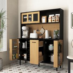 a kitchen with wooden cabinets and black counter tops, white tile flooring and a potted plant in the corner