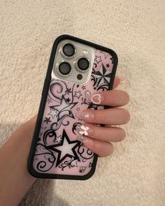 a woman's hand holding an iphone case with stars on it